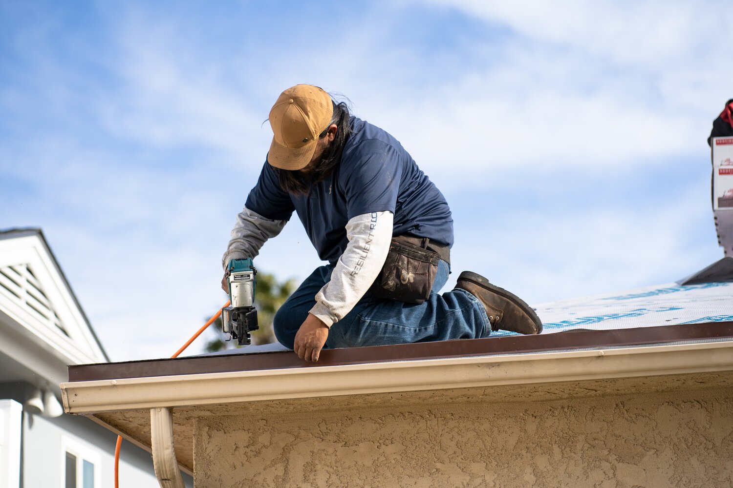 Professional roofer working on roof installation